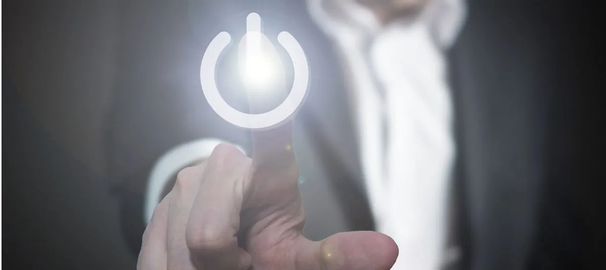 Business professional activating services by pressing a virtual power button on a touchscreen interface.
